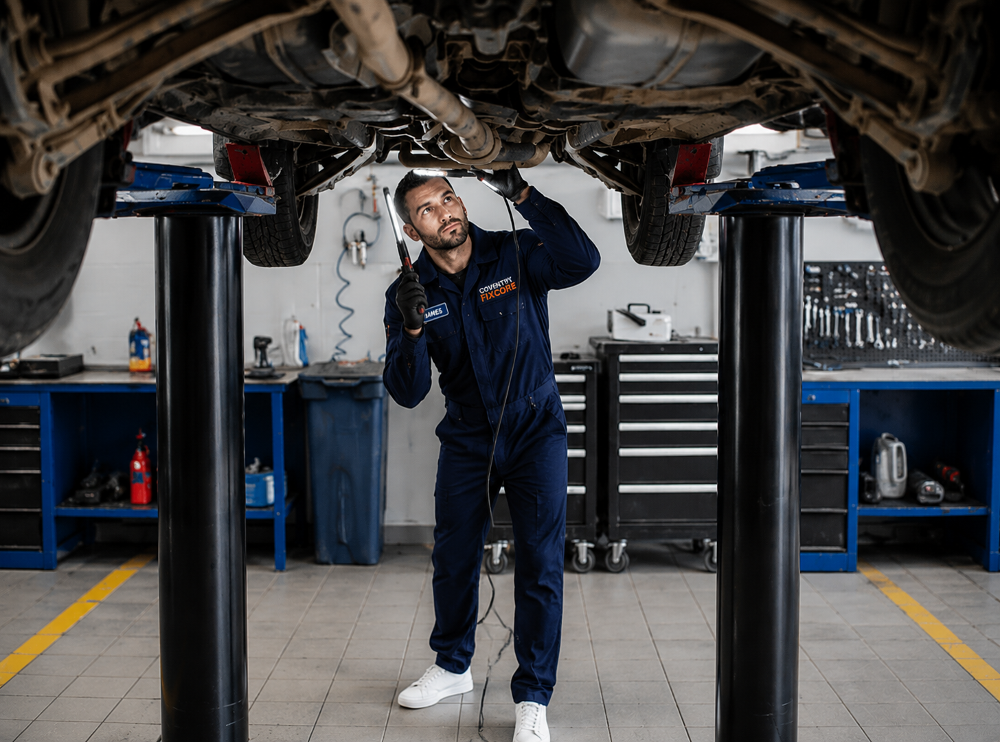 Mobile mechanic fitting a replacement car battery at a vehicle in Coventry