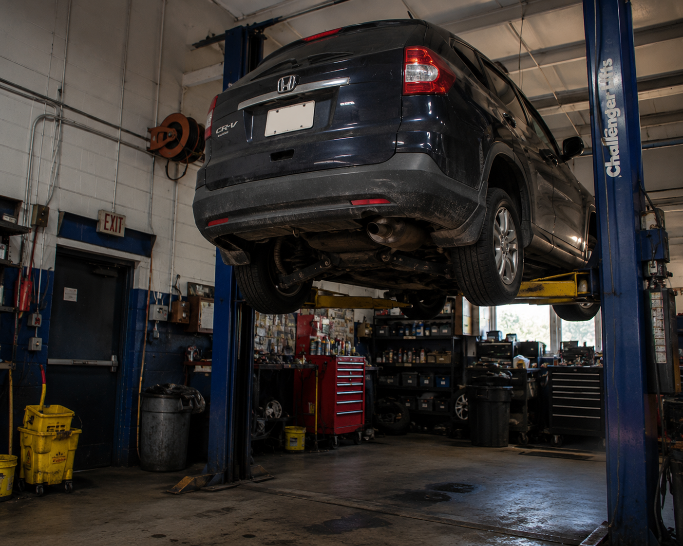 Mechanic inspecting front rear and four-wheel alignment on a vehicle in Coventry